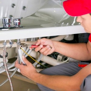 Plumber Fixing Kitchen Sink